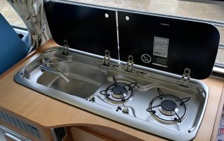 Sink and gas hob on campervan kitchen unit